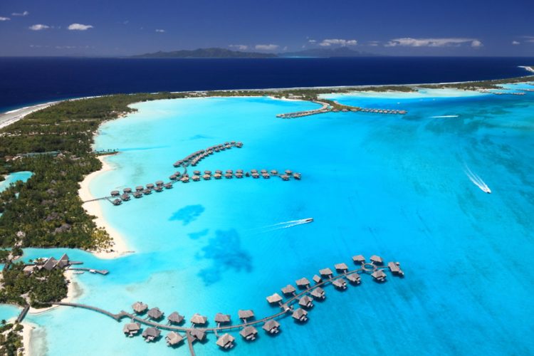 Bora Bora Lagoon, French Polynesia from above. Dreamlike colors. Some Overwater Bungalows are in View